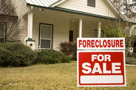 House with foreclosure sign in front.