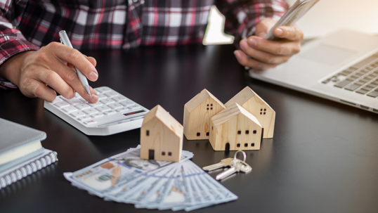 Homeowner reviewing mortgage and repossession options with calculator.