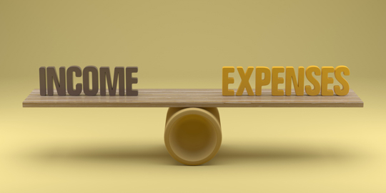 Balance scale comparing income and expenses to represent financial pressure