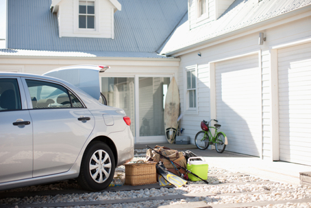 ar parked outside home with personal belongings visible